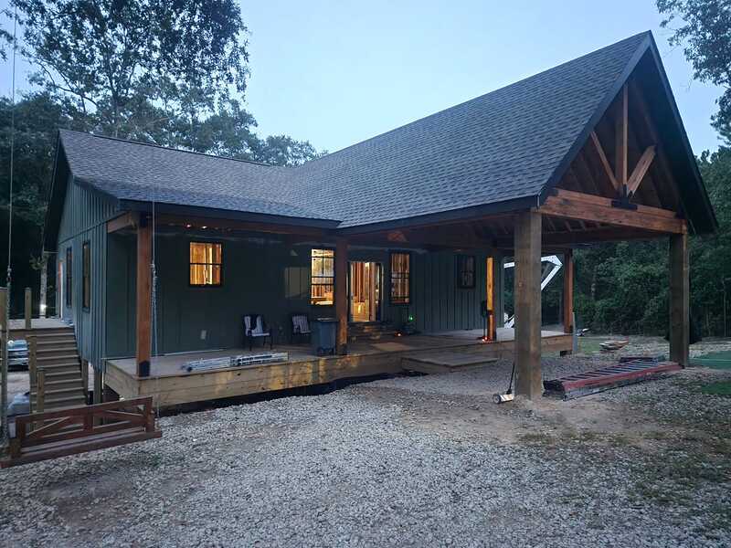 Custom timber-framed porch and breezeway at dusk