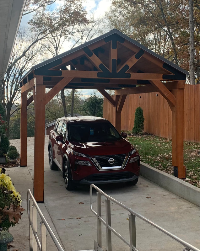 Custom carport with decorative truss and steel detailing