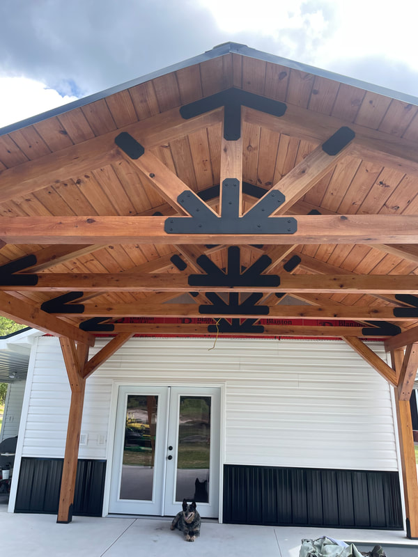Detailed view of pavilion king-post trusses with black steel plating